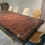 High-Gloss Amber Burl Wood Dining Table with Cream Quilted Leather Base and Metal Inlay